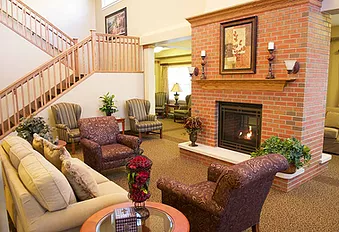REcreation room with chairs in front of a fireplace