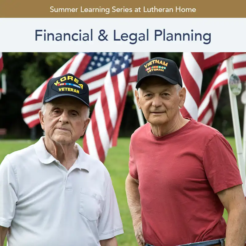 veteran males with veteran hats stand outside in front of the american flags
