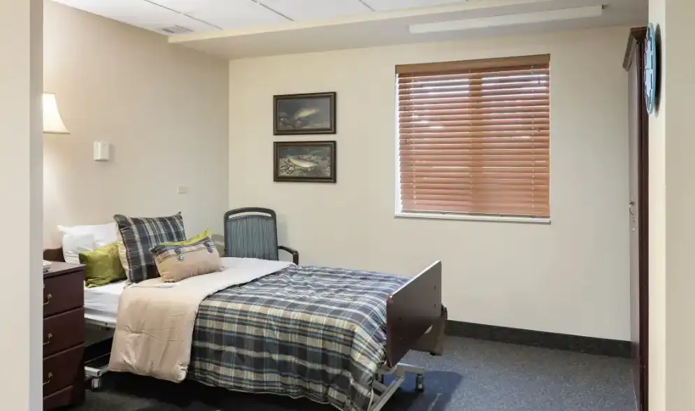 a room with a bed and a covered window with light walls