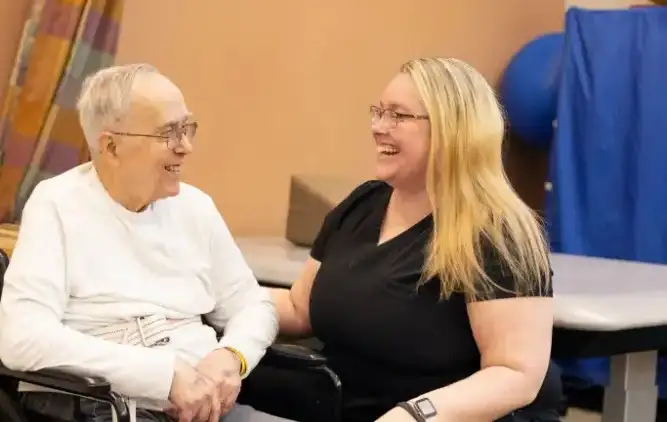 a health care professional assists an older man