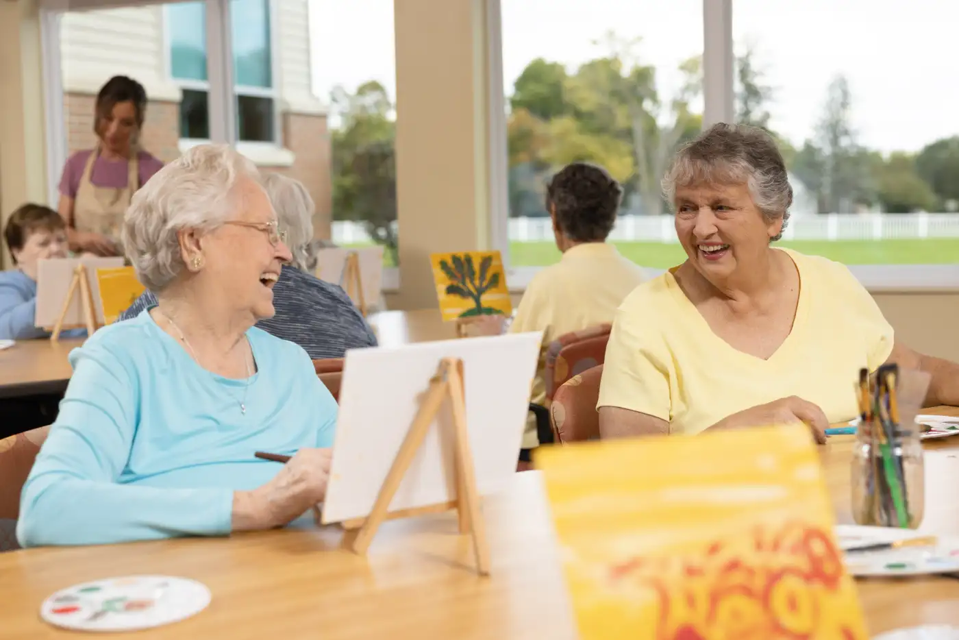 a group of seniors take a painting class together